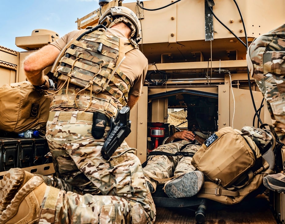 A tactical medical team tending to a patient in a field facility
