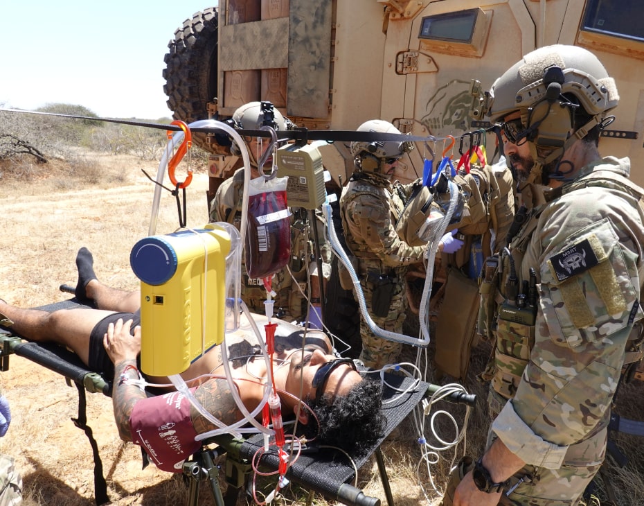 A tactical medical team tending to a patient in the field